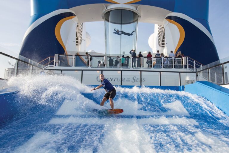Girl surfing on a surf simulator on the Quantam of the Seas Cruise Ship